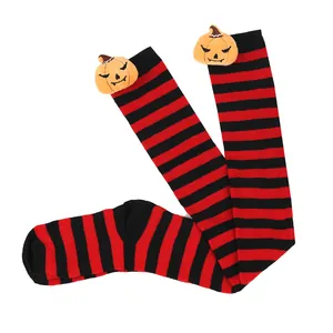 Halloween red and black striped over-the-knee socks featuring cute plush pumpkin doll