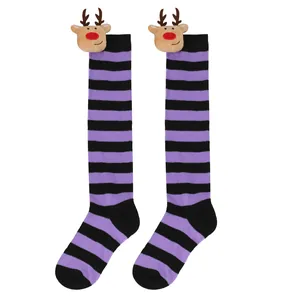 Detail view of purple and black striped Christmas knee-high socks with reindeer doll