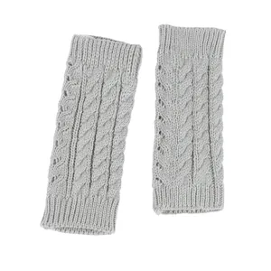 Close-up of grey cable-knit arm warmers with hollow design and textured wool finish