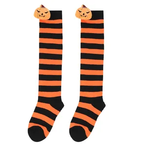 Detail view of orange and black striped Halloween socks with plush pumpkin dolls.