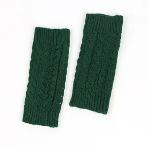Detailed view of dark green cable knit fingerless gloves with hollow twist pattern