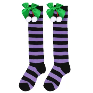 Girls' purple and black striped knee-high socks with green bows and white pom-poms