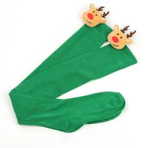 Detail view of green over-the-knee Christmas stockings with cute plush reindeer heads.