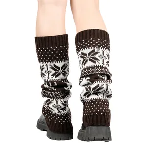Back view of brown knitted leg warmers with white snowflake patterns worn with boots