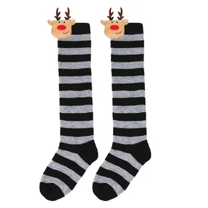 Detailed view of children's Christmas knee-high socks featuring plush reindeer decor