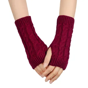 Detailed view of burgundy cable knit fingerless gloves featuring soft wool texture and thumb holes