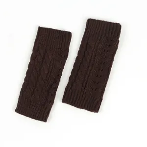 Detailed view of dark brown cable knit fingerless gloves with elegant hollow pattern