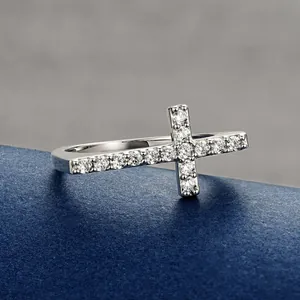 Detailed macro view of a 14k gold-filled cross ring encrusted with shiny round zircons
