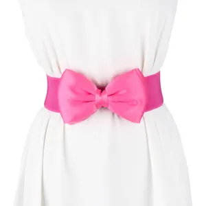 Close-up detail of a vibrant pink elastic waist belt featuring a large satin bow.