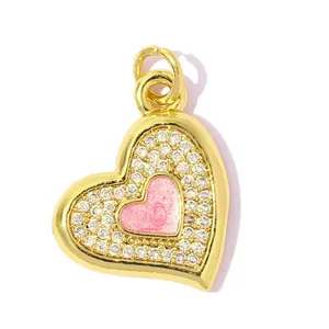 Detailed view of gold-plated heart pendant with pink enamel and sparkling zirconia