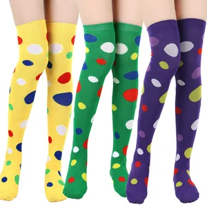 Close-up of colorful polka dot over-the-knee socks in yellow green and purple