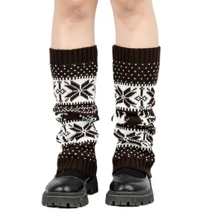 Detailed view of knitted Christmas leg warmers featuring festive snowflake and deer patterns.
