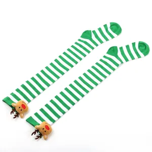 Detailed view of green striped Christmas over-the-knee socks with reindeer plush decoration