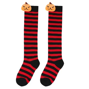 Detail of Halloween striped knee-high socks with plush pumpkin doll decoration for kids
