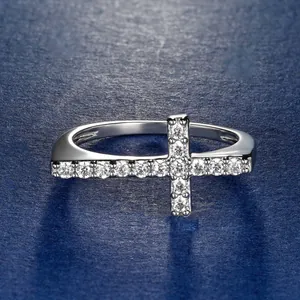 Detailed macro view of a silver-toned cross ring set with sparkling round cubic zirconia.
