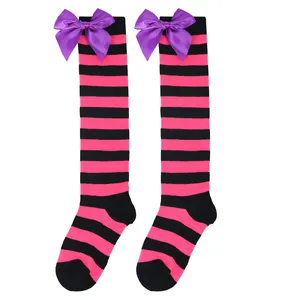 Pink and black striped children's over-the-knee socks with vibrant purple satin bows.