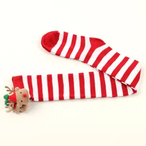 Detail view of Christmas red white striped over-knee socks with plush reindeer