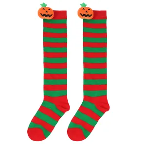Macro view of Halloween striped socks featuring adorable orange plush pumpkin doll details.