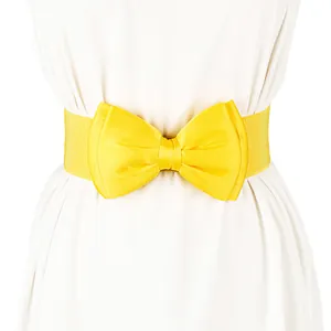 Close-up detail of a bright yellow elastic waist belt with a large satin bow accent.
