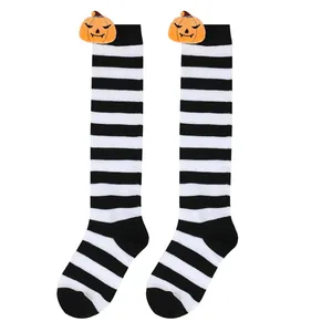 Detail view showing black and white striped Halloween socks with plush pumpkin dolls.