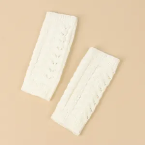 Detailed view of white cable-knit fingerless gloves for autumn and winter warmth