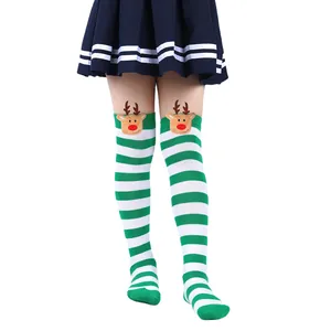 Detailed close-up of festive green and white striped Christmas socks with reindeer