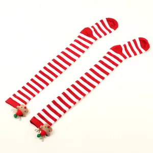Detail of festive Christmas over-the-knee striped socks featuring plush reindeer accents