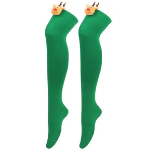 Detail view of green over-the-knee Christmas socks with cute plush reindeer heads.