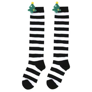 Detail view of children's black and white striped Christmas socks with plush tree