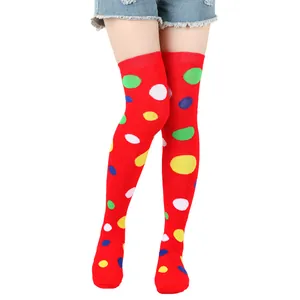 Detailed view of red over the knee socks featuring vibrant colorful polka dot patterns