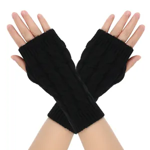 Macro view of black cable-knit fingerless gloves with soft acrylic texture for winter