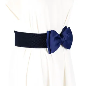 Close-up detail of navy blue elastic waist belt with large decorative bow