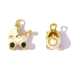 Detailed view of gold-plated baby stroller charms with white enamel and blue stones