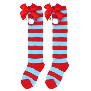 Red and blue striped Christmas knee-high socks with decorative red bow and white pom poms
