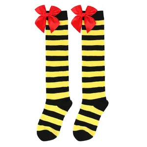 Detailed view of yellow and black striped knee-high socks with large red bows