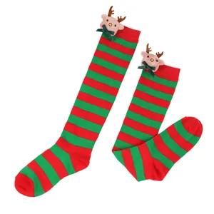 Detail showing plush reindeer doll with green bow on red and green striped socks