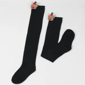 Black over-the-knee socks featuring a cute plush reindeer decoration on top detail view.