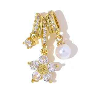Detailed macro shot of a gold-plated daisy flower pendant set with zircons and pearl