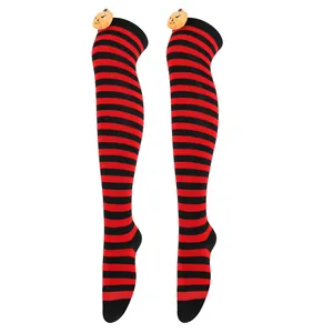 Detail of Halloween striped over-the-knee socks with plush pumpkin doll decoration