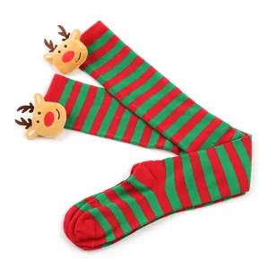 Detailed view of red and green striped Christmas over-the-knee socks with plush reindeer decoration
