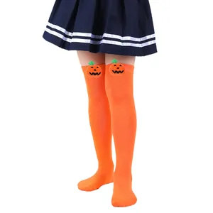 Detailed view of kids orange over-the-knee Halloween socks with 3D pumpkin dolls
