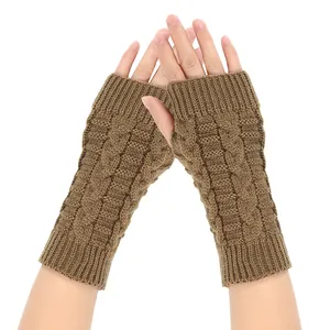 Detailed close-up of brown cable-knit fingerless gloves highlighting the warm texture.