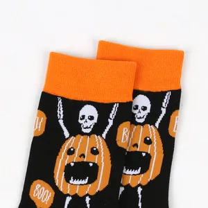 Close-up of Halloween crew socks featuring skeletal pumpkin character with 'BOO!' text