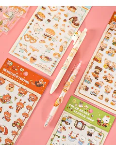 Close-up detail of cute cartoon animal waterproof stickers and matching gel pens for journaling