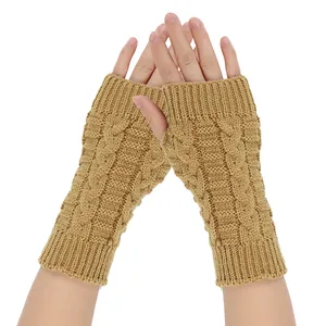 Close-up of cable knit fingerless gloves in camel color showing texture and fit