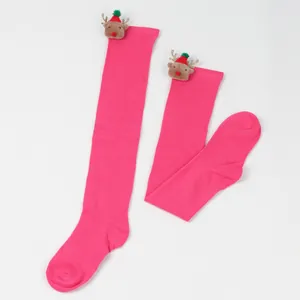 Detail view of festive magenta over-the-knee socks with cute 3D reindeer plush ornaments