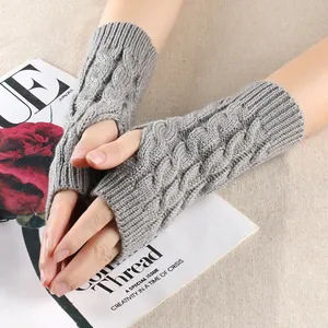 Close-up of grey cable knit fingerless gloves with delicate 8-character twist texture