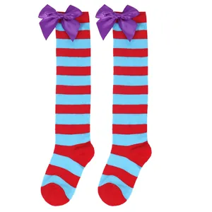 Close-up detail of red and blue striped knee-high socks featuring a purple satin bow ornament