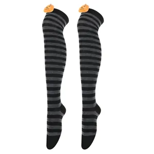 Detail showing Halloween over-the-knee socks with pumpkin plush decor and stripes.
