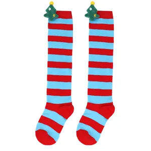 Close-up of kids' Christmas knee-high socks with red and blue stripes and plush trees